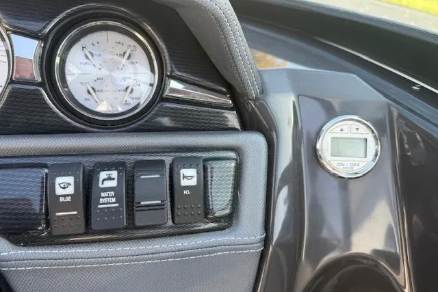 Slide: The Image of Control panel of a 2018 Monterey 224FS boat with switches and Fusion MS-NRX300. - 10