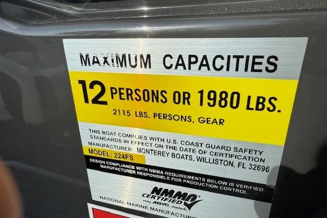 Slide: The Image of 2018 Monterey 224FS boat interior view, parked on a trailer, with a truck in the background. - 14