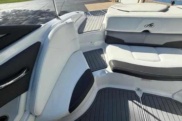 Slide: The Image of 2018 Monterey 224FS boat interior with sleek seating and modern steering wheel. - 21