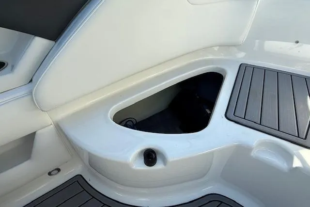 Slide: The Image of 2018 Monterey 224FS boat interior with white seating and gray flooring. - 23