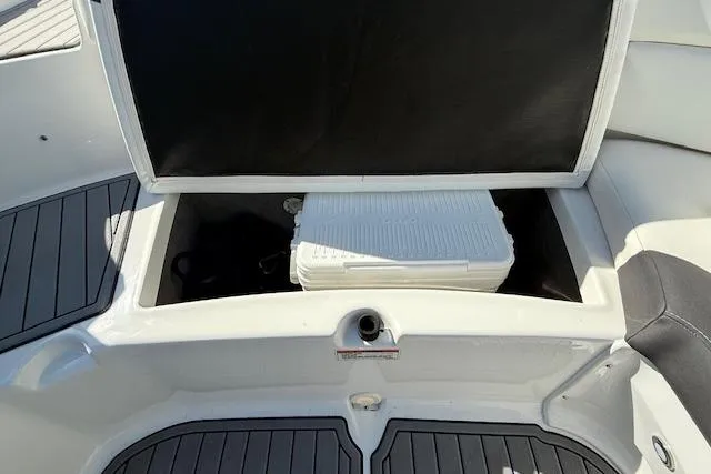 Slide: The Image of 2018 Monterey 224FS boat interior storage compartment with sleek white design. - 24