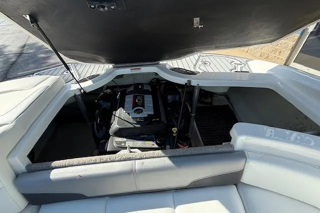 Slide: The Image of 2018 Monterey 224FS boat engine compartment with open hatch, showcasing interior mechanics. - 27