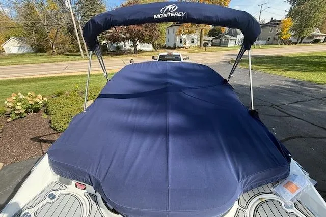 Slide: The Image of 2018 Monterey 224FS boat on trailer, parked outdoors under clear sky. - 38