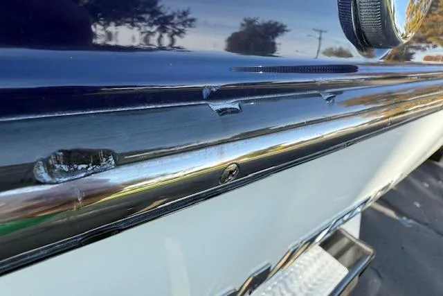 Slide: The Image of 2018 Monterey 224FS boat with blue cover, parked on a driveway, surrounded by trees and houses. - 39