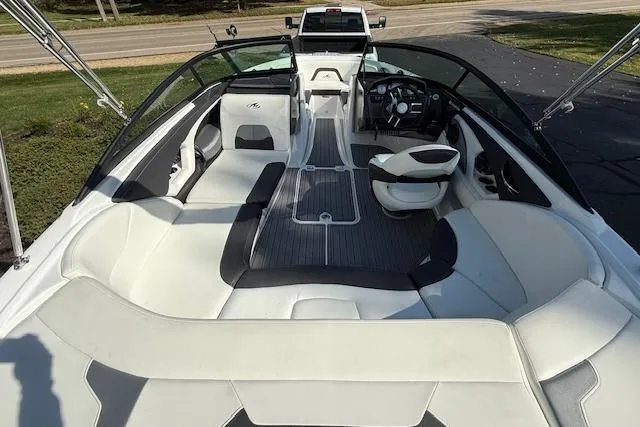 Slide: The Image of 2018 Monterey 224FS boat with spacious seating and canopy, parked outdoors. - 5