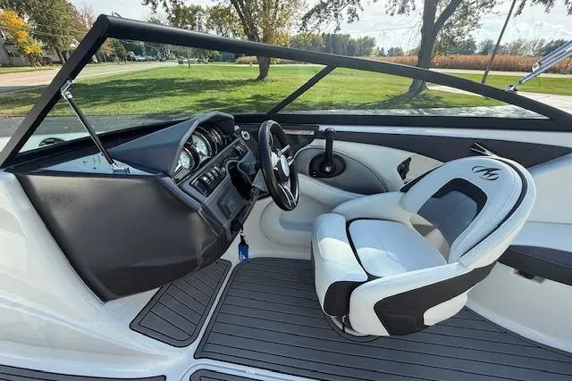 Slide: The Image of 2018 Monterey 224FS boat interior with steering wheel and seating, showcasing modern design. - 7
