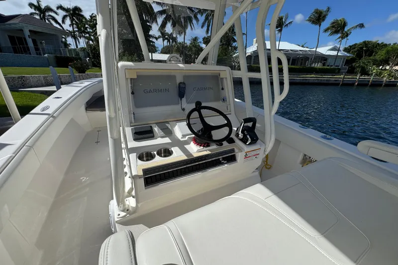 Slide: The Image of 2023 SeaVee 340Z boat cockpit with Garmin navigation system, steering wheel, and seating. - 12