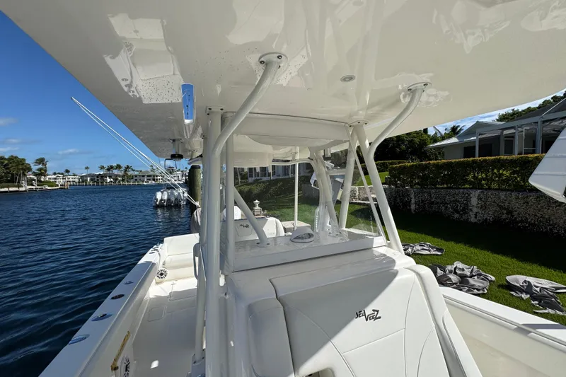 Slide: The Image of 2023 SeaVee 340Z boat docked by waterfront homes under clear blue sky. - 14