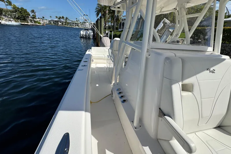 Slide: The Image of 2023 SeaVee 340Z boat, sleek white design, docked by a calm waterfront. - 15