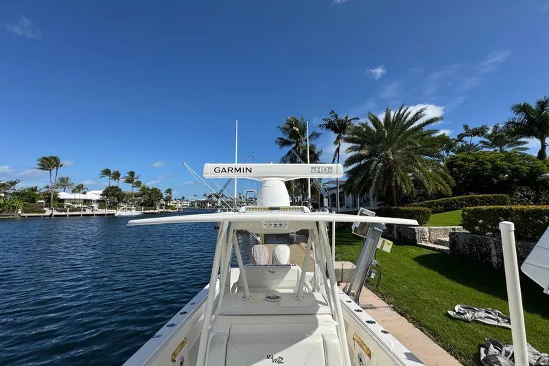 Slide: The Image of 2023 SeaVee 340Z boat docked by palm trees, featuring Garmin xHD2 radar. - 16