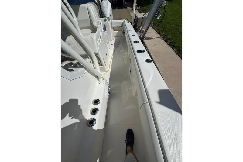 Slide: The Image of 2023 SeaVee 340Z boat interior with rod holders and seating, docked by the water. - 28