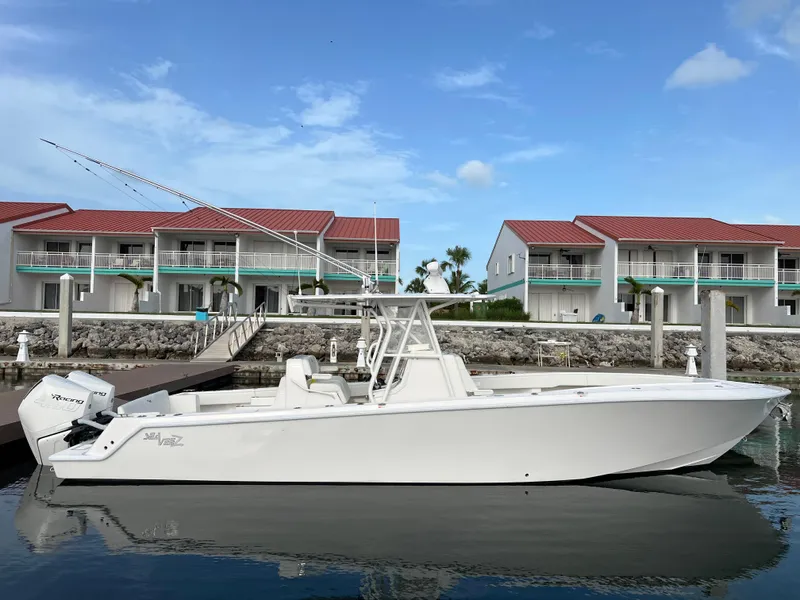 Slide: The Image of 2023 SeaVee 340Z boat docked near waterfront homes. - 3