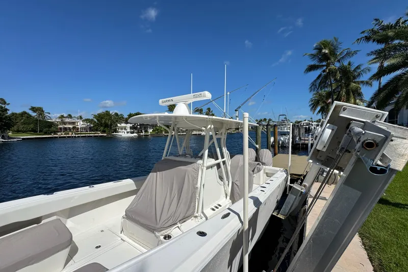Slide: The Image of 2023 SeaVee 340Z boat docked by waterfront, clear blue sky, palm trees. - 30