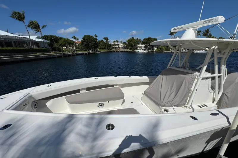Slide: The Image of 2023 SeaVee 340Z boat docked by waterfront homes under clear blue sky. - 31