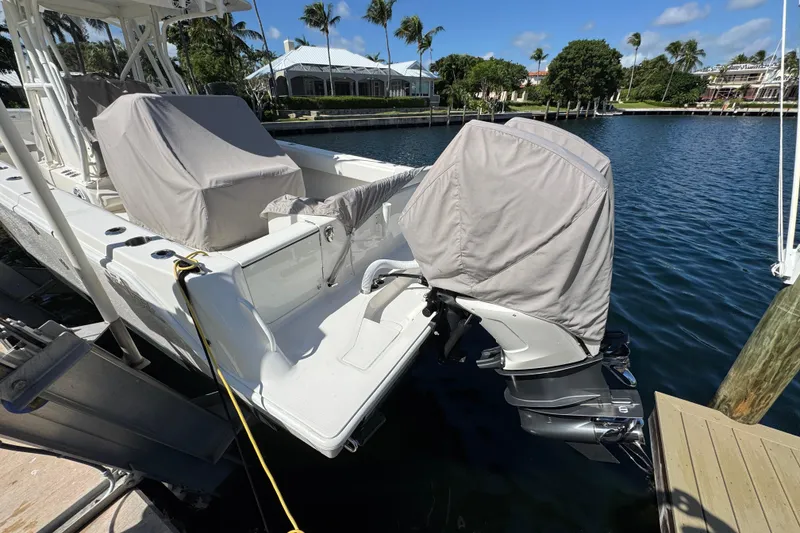 Slide: The Image of 2023 SeaVee 340Z boat docked with covered engines, scenic waterfront view. - 32