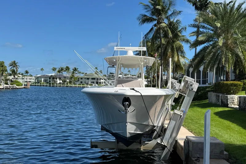 Slide: The Image of 2023 SeaVee 340Z boat docked by palm trees and waterfront homes. - 33