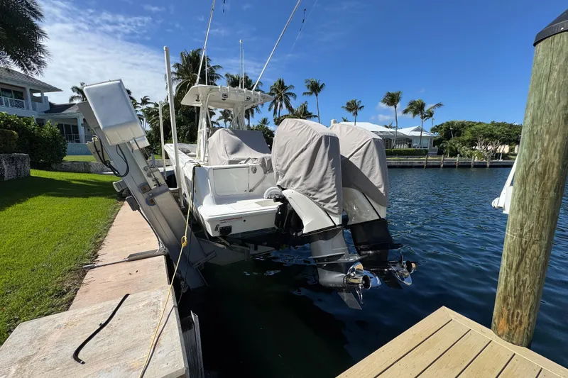 Slide: The Image of 2023 SeaVee 340Z boat docked, covered engines, sunny waterfront setting. - 35