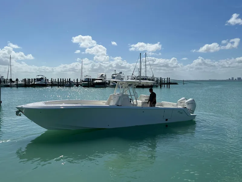 Slide: The Image of 2023 SeaVee 340Z boat on calm water with marina background. - 4