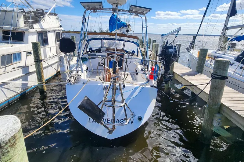 Slide: The Image of 1980 Nordic 44 sailboat docked at marina, clear sky, calm water. - 10