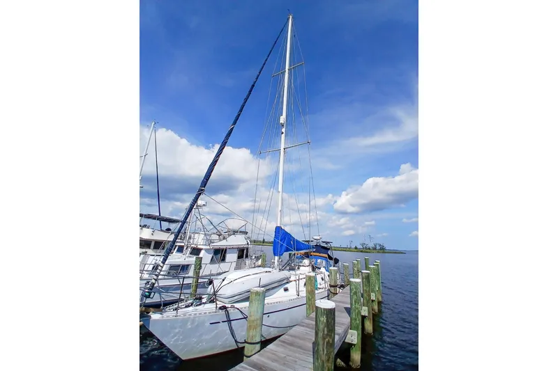 Slide: The Image of 1980 Nordic 44 sailboat docked at marina under clear blue sky. - 14