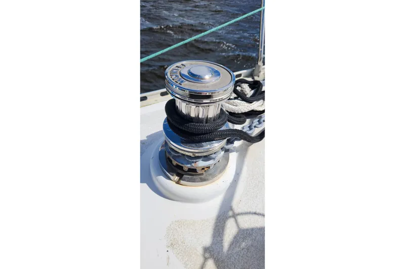 Slide: The Image of Winch on 1980 Nordic 44 sailboat deck with ropes, ocean in background. - 18