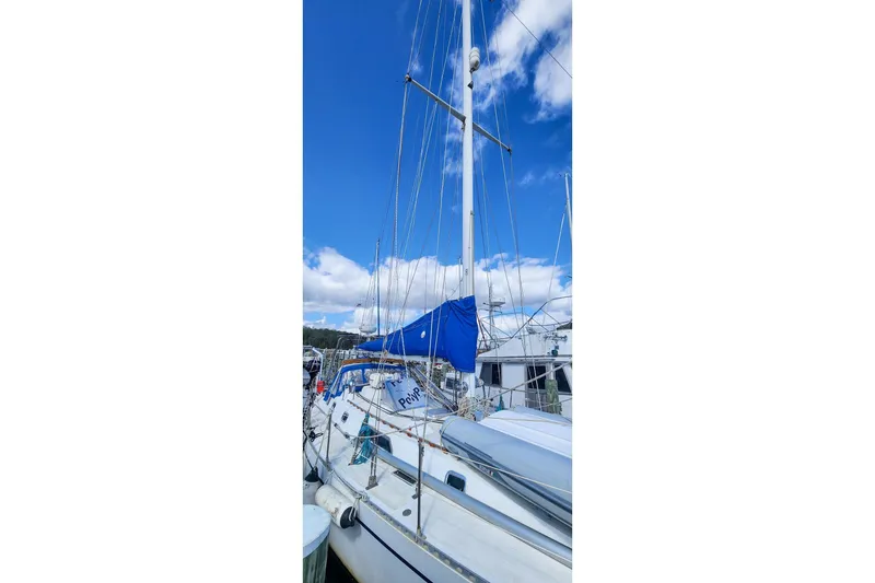 Slide: The Image of Sailboat Nordic 44, 1980 model, docked under a clear blue sky. - 2