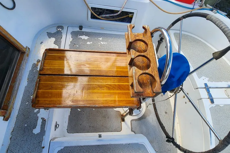 Slide: The Image of Cockpit of 1980 Nordic 44 sailboat with wooden table and cup holders. - 20