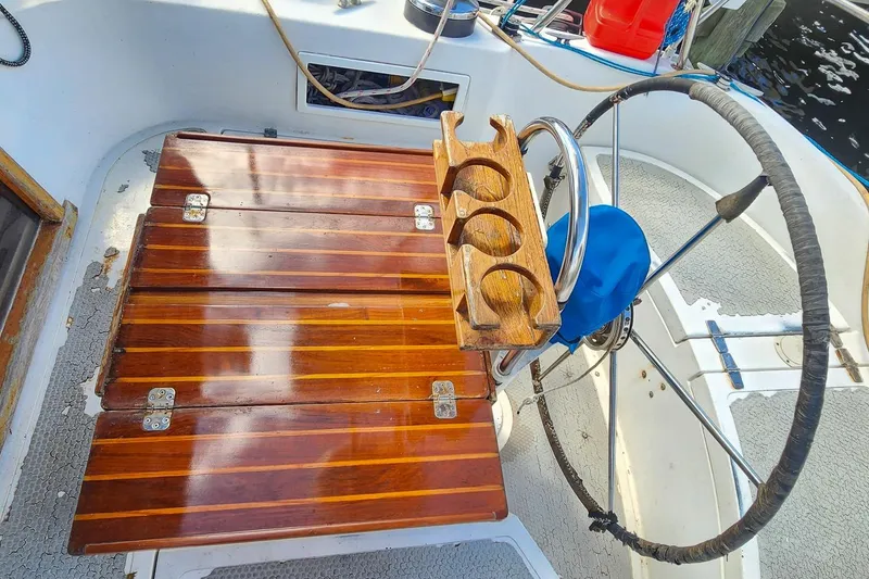 Slide: The Image of Cockpit of 1980 Nordic 44 sailboat with wooden table and steering wheel. - 21