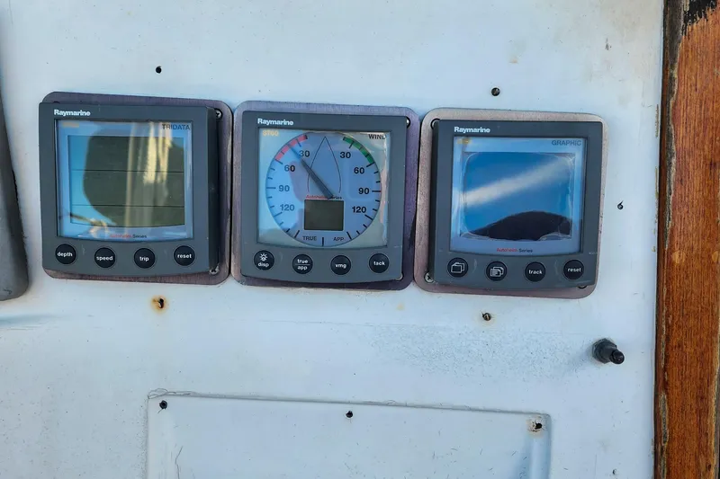 Slide: The Image of Raymarine navigation instruments on a 1980 Nordic 44 sailboat dashboard. - 25