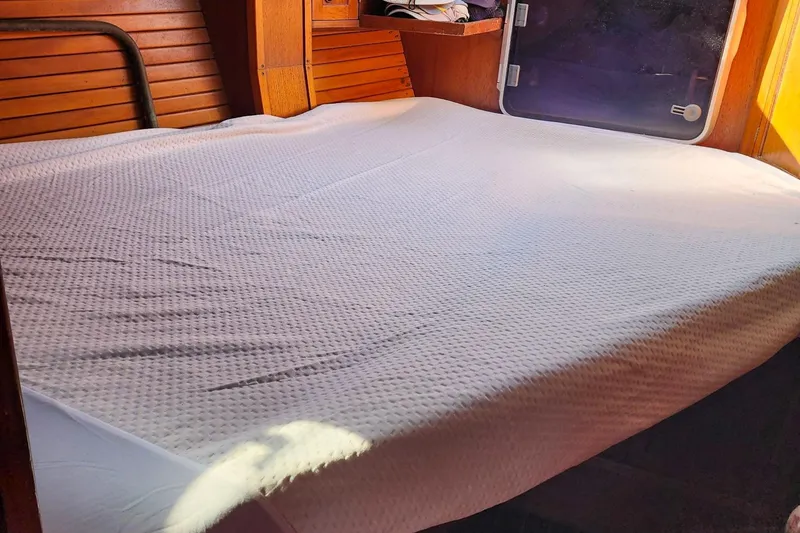 Slide: The Image of Cozy cabin bed in 1980 Nordic 44 sailboat with wooden interior. - 34