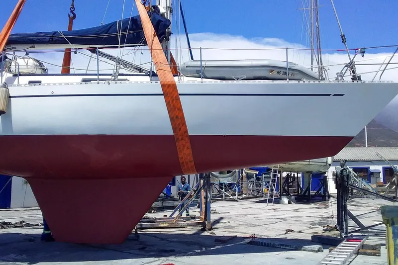 Slide: The Image of Sailboat Nordic 44 from 1980 in dry dock, showcasing its hull and keel. - 37