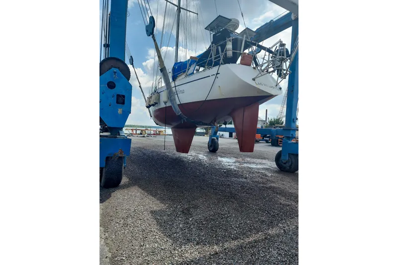 Slide: The Image of Nordic 44 sailboat from 1980 being lifted in a boatyard. - 40