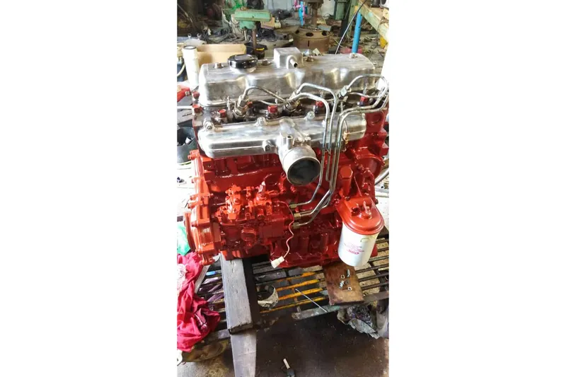 Slide: The Image of 1980 Nordic 44 engine, red and silver, in a workshop setting. - 45