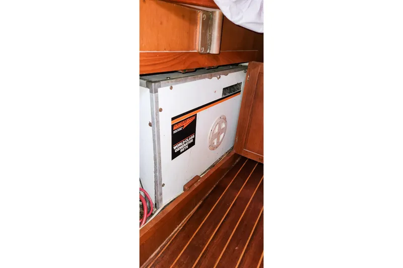Slide: The Image of 1980 Nordic 44 yacht interior with generator, wooden cabinetry, and flooring. - 46