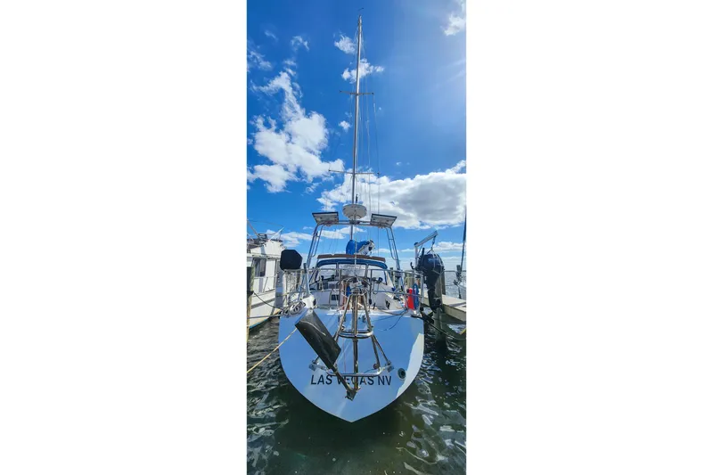 Slide: The Image of 1980 Nordic 44 sailboat docked under a bright blue sky. - 6