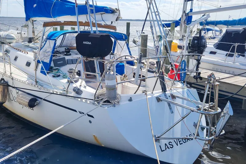 Slide: The Image of Sailboat Nordic 44 from 1980 docked, featuring blue sails and a Magma grill. - 7