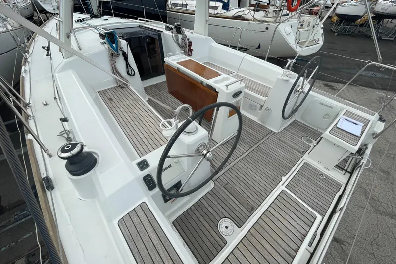 Slide: The Image of 2016 Beneteau Oceanis 38 sailboat cockpit with dual steering wheels and teak decking. - 11