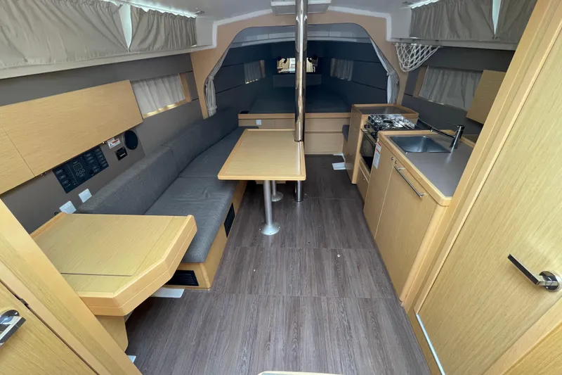 Slide: The Image of Interior of 2016 Beneteau Oceanis 38 sailboat with modern kitchen and seating area. - 18