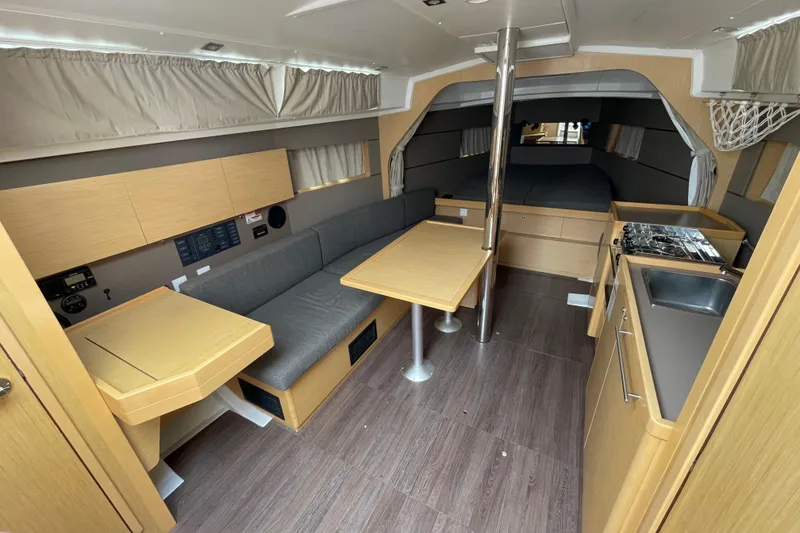 Slide: The Image of Interior of 2016 Beneteau Oceanis 38 sailboat with modern kitchen and seating area. - 19