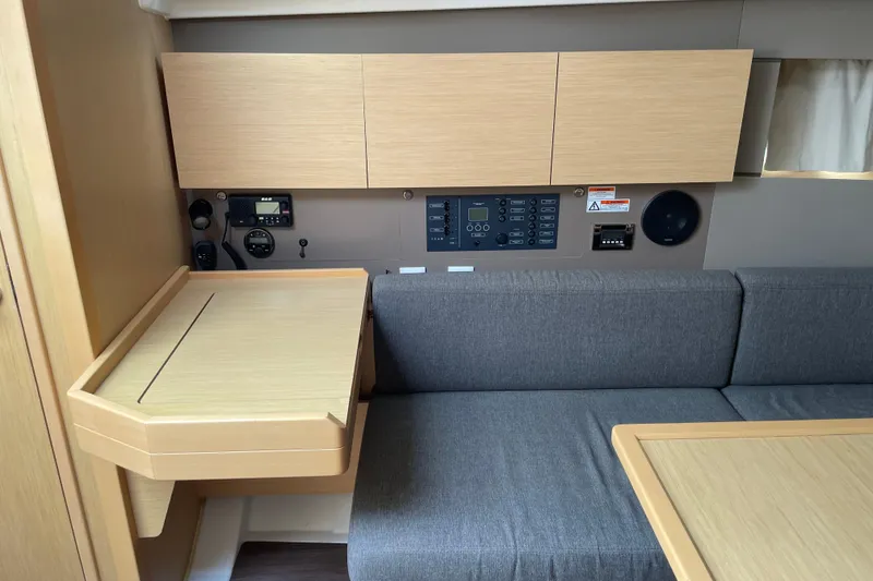 Slide: The Image of Interior of 2016 Beneteau Oceanis 38 yacht with navigation station and seating area. - 20