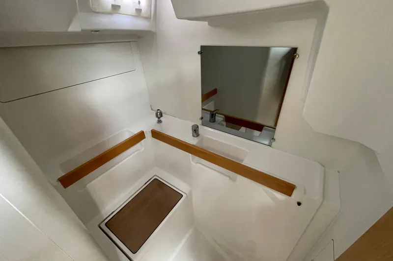 Slide: The Image of 2016 Beneteau Oceanis 38 bathroom interior with mirror and wooden accents. - 26