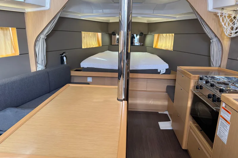 Slide: The Image of Interior of 2016 Beneteau Oceanis 38 yacht with kitchen, dining area, and bed. - 28