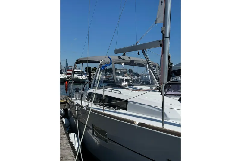 Slide: The Image of 2016 Beneteau Oceanis 38 sailboat docked at marina under clear blue sky. - 3