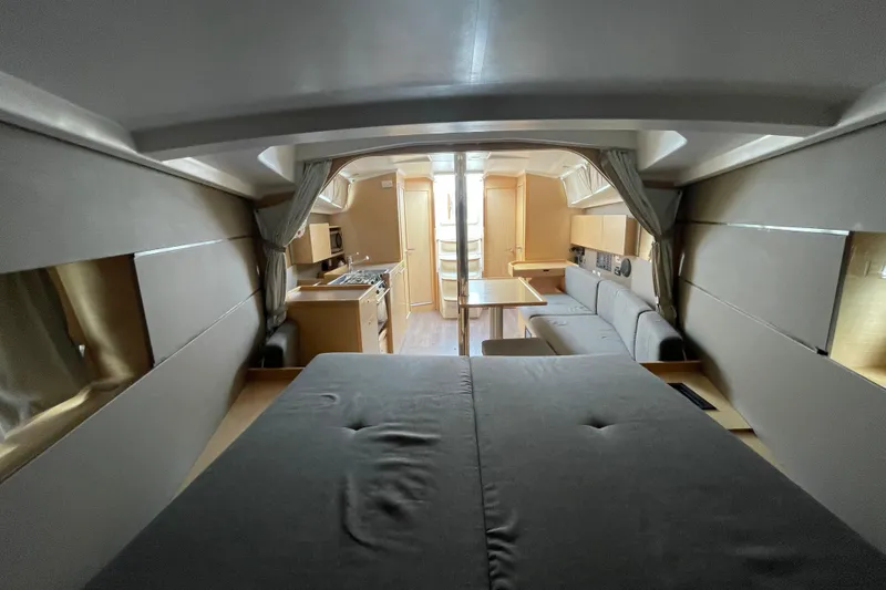 Slide: The Image of Interior of 2016 Beneteau Oceanis 38 yacht, featuring modern kitchen and cozy seating area. - 32