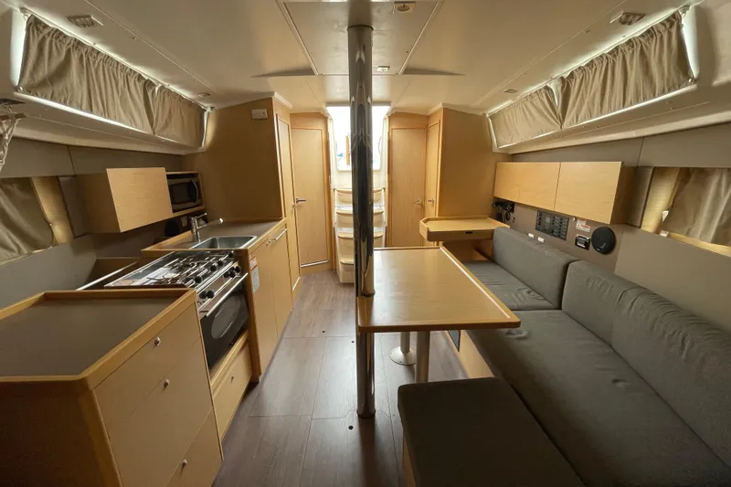 Slide: The Image of Interior of 2016 Beneteau Oceanis 38 yacht with modern kitchen and seating area. - 33