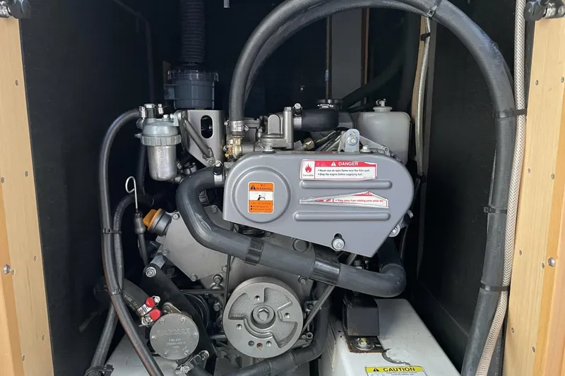 Slide: The Image of Engine compartment of a 2016 Beneteau Oceanis 38 sailboat, showcasing mechanical components. - 35