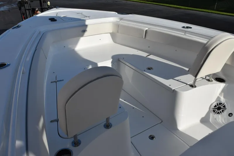 Slide: The Image of 2026 Sea Hunt Ultra 265 SE boat interior with white seating and storage compartments. - 12