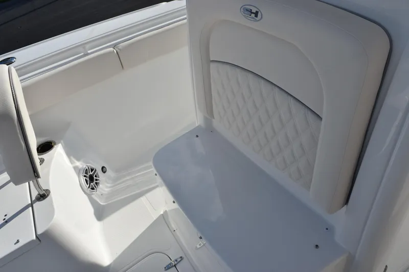 Slide: The Image of 2026 Sea Hunt Ultra 265 SE boat interior with white cushioned seating. - 13