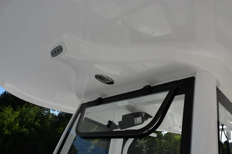 Slide: The Image of 2026 Sea Hunt Ultra 265 SE boat roof detail with window and speaker. - 14