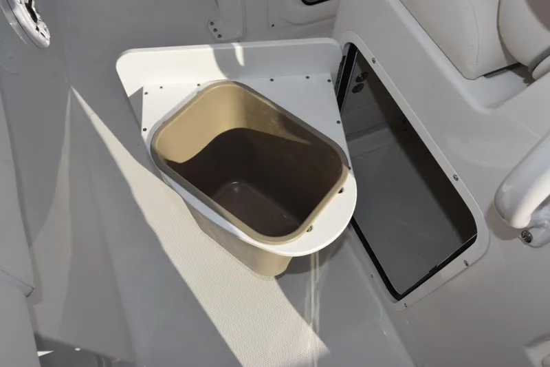 Slide: The Image of Interior of 2026 Sea Hunt Ultra 265 SE boat with storage compartment and bin. - 16